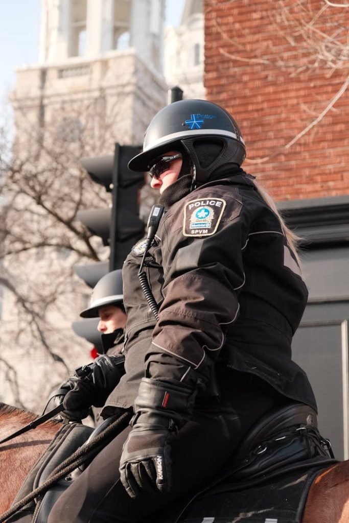 police-officer-on-horse-20741536 Police officers on horseback patrolling the city, showcasing urban law enforcement.